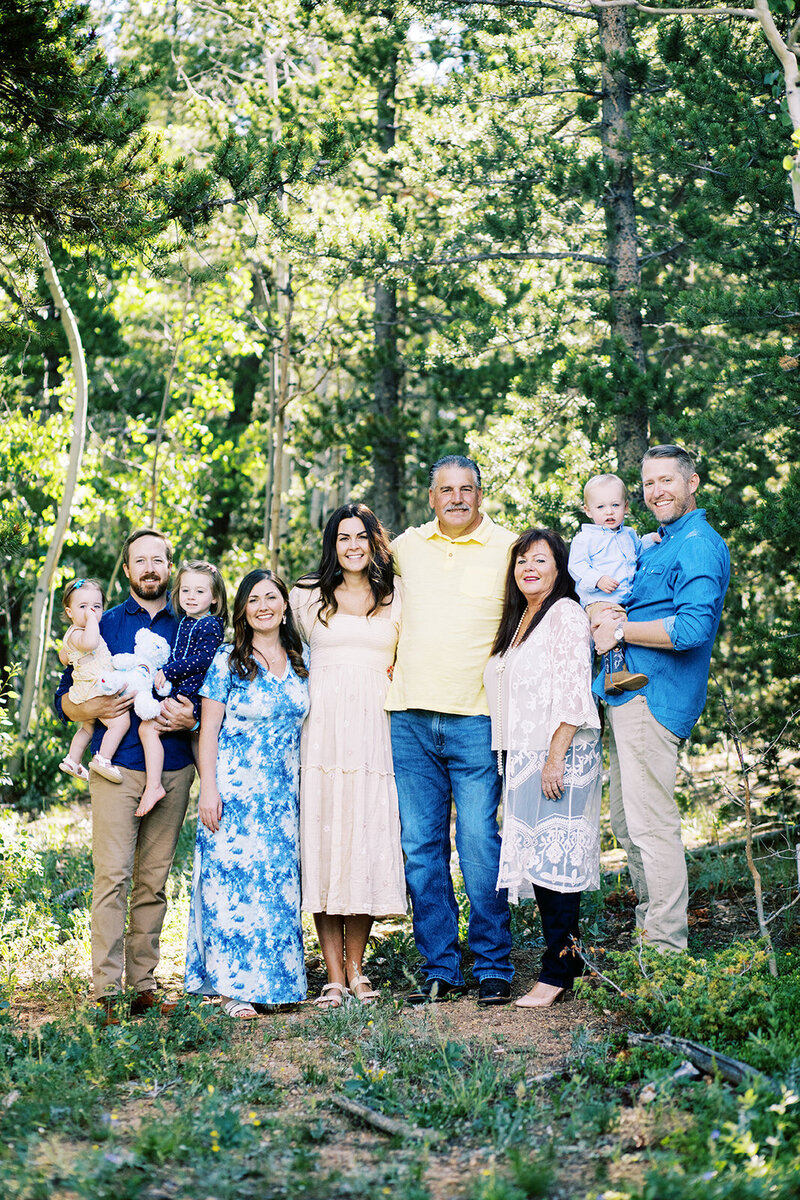 3 generations of family pose in the woods outside of nederland, colorado