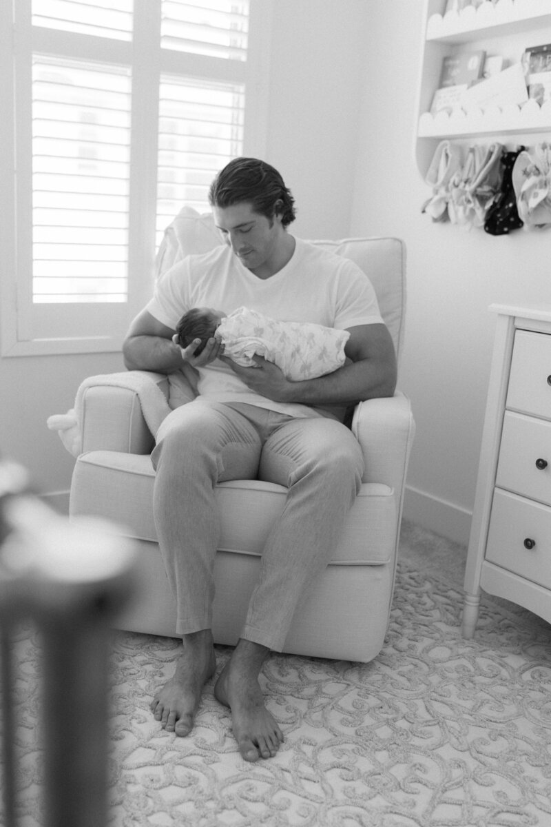 newborn in father's arms photo