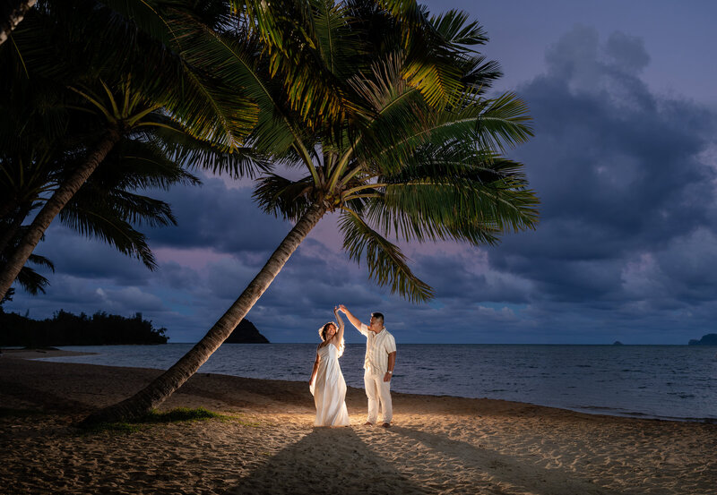 Oahu Hawaii elopement bride and groom at Secret Island Beach at Sunset Blue Hour near palm trees.