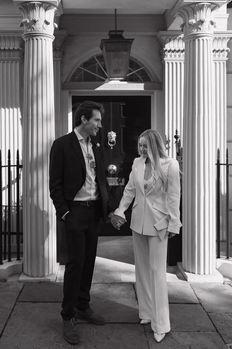 A close angle of a bride looking over her shoulder admiring her luxury wedding decor at hedor house cotswolds