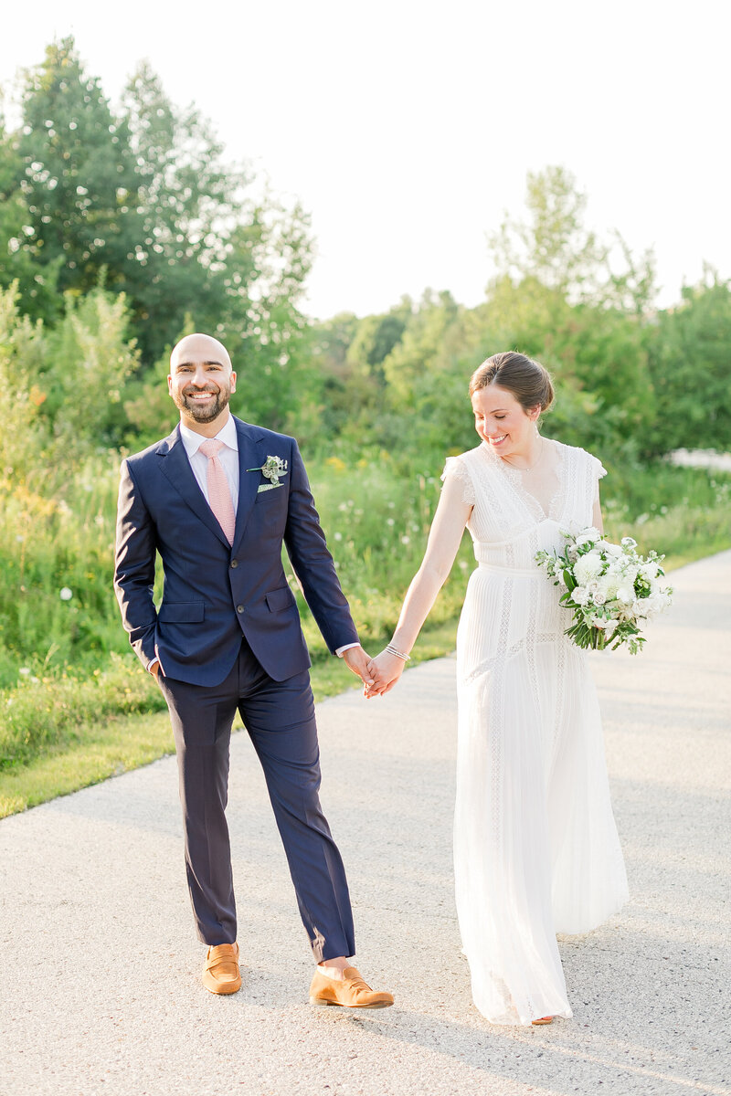 8_bride_and_groom_walking_across_road_at_sunset