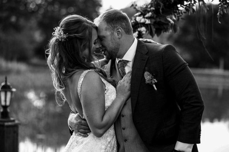 Bride and groom touching foreheads at Rustic Acres wedding