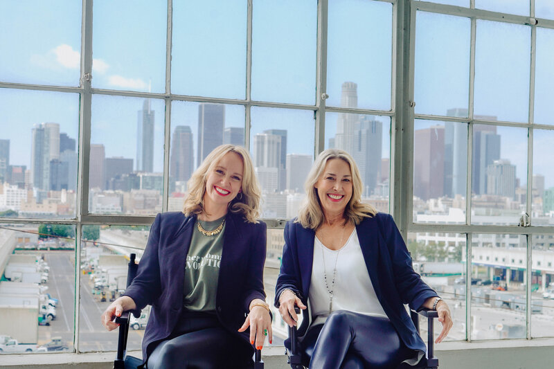 two woman smiling together