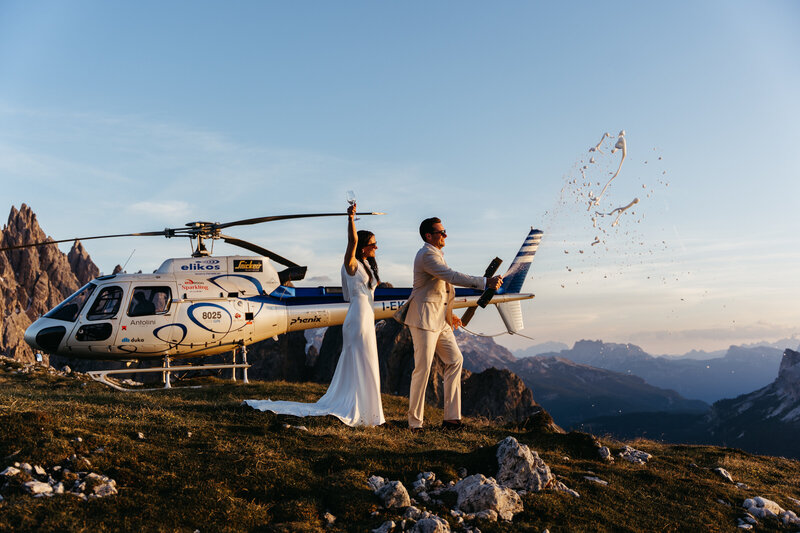 Couple eloping with views of Cadini di Misurina with helicopter