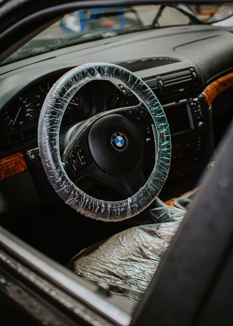 BMW interior with covered steering wheel
