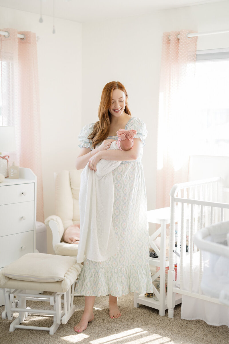 mama holding baby in nursery