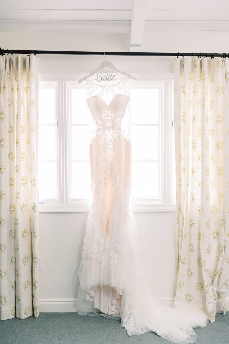 A soft and airy lace wedding gown framed by natural light, setting the scene for a dreamy destination wedding.