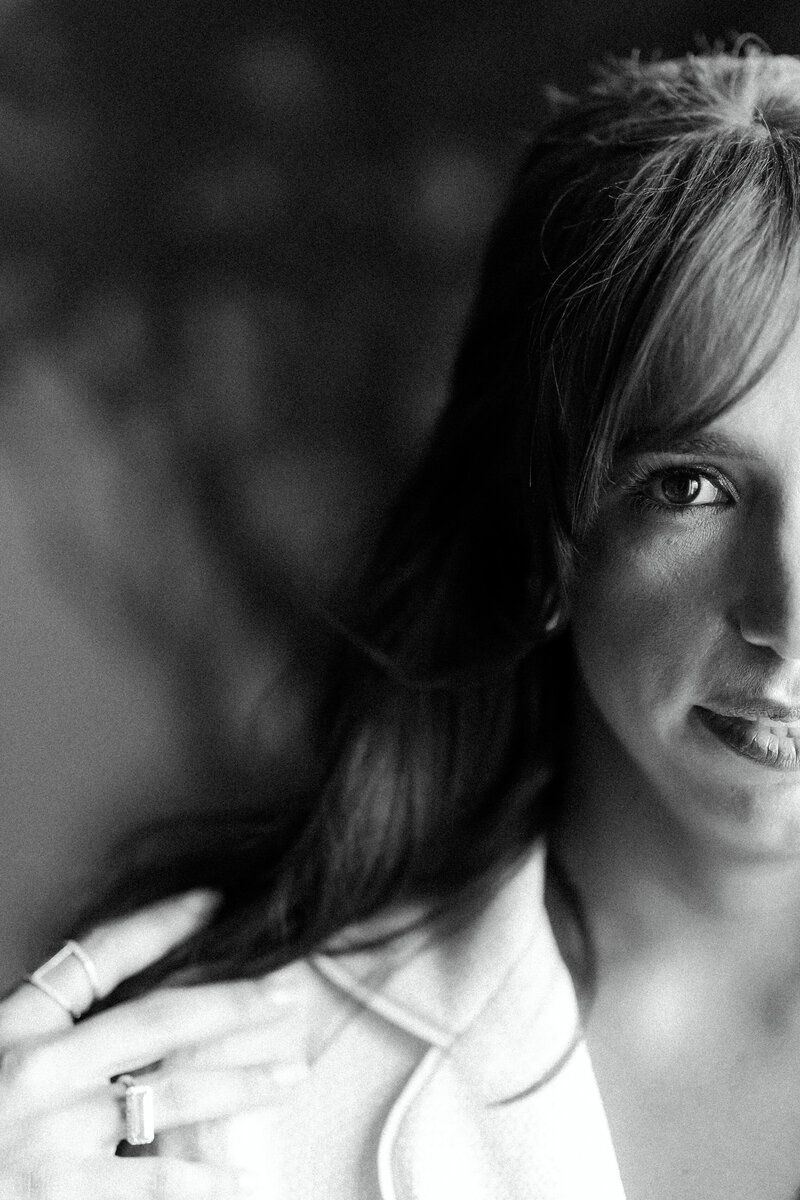 A stunning black and white bridal portrait at Commodore Perry Estate in Austin, Texas, capturing the bride’s soft expression and delicate details of her engagement ring and elegant attire.