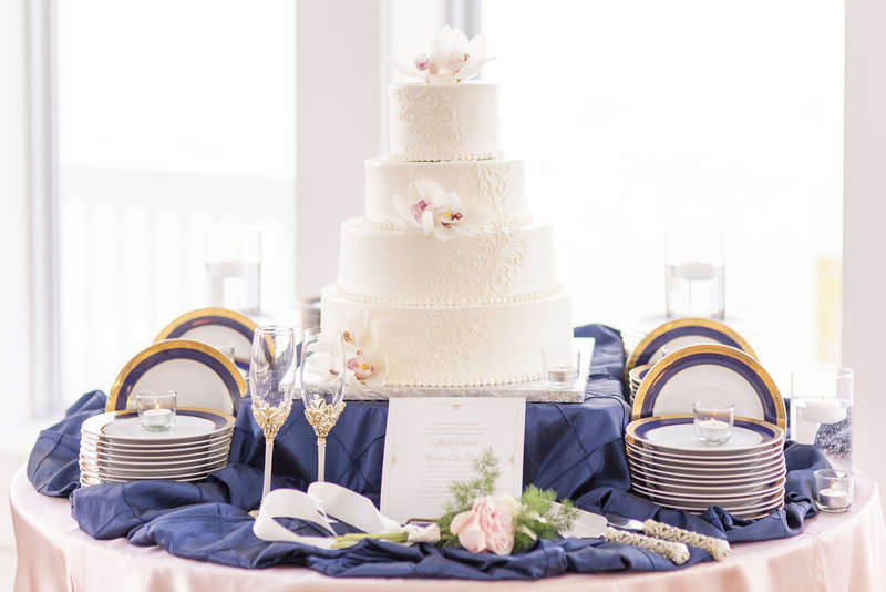 Sullivan Photography Wedding Detail Photo of a Wedding Cake & Dinnerware, in Navy, Blush, White, and Gold