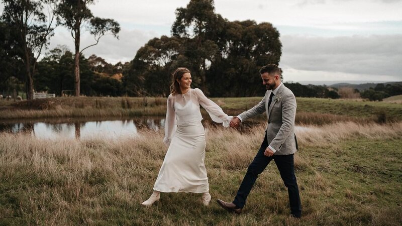 melbourne wedding photographer captures couple walking  at their backyard wedding near Melbourne