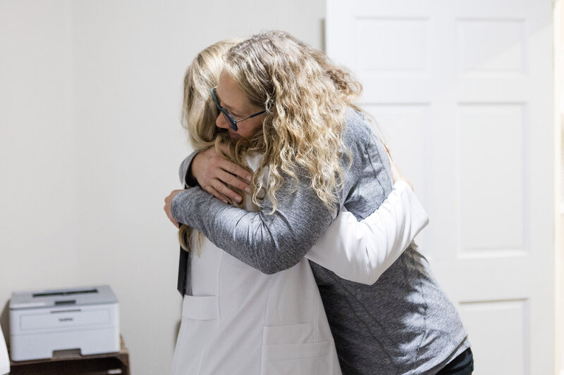 Jamie hugging a patient in the clinic