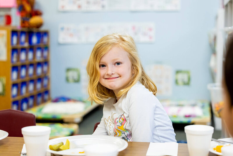 smiling girl eating lunch