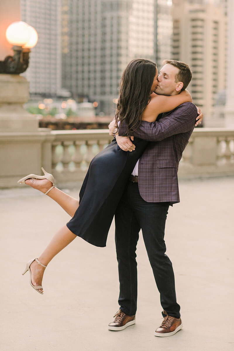An engagement photo taken at Wrigley Plaza in downtown Chicago