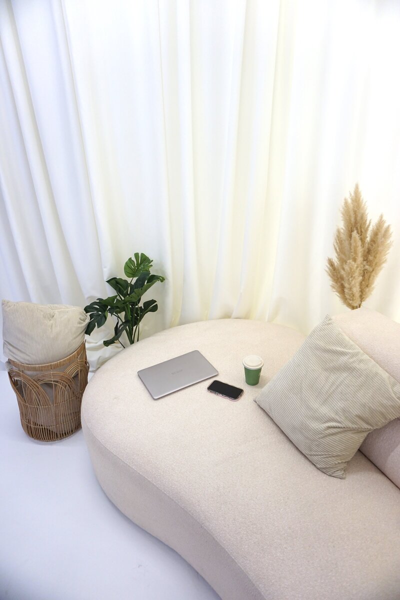 Curated scene with a comfy sofa, laptop, phone and coffee - perfect for creating workflows and processes