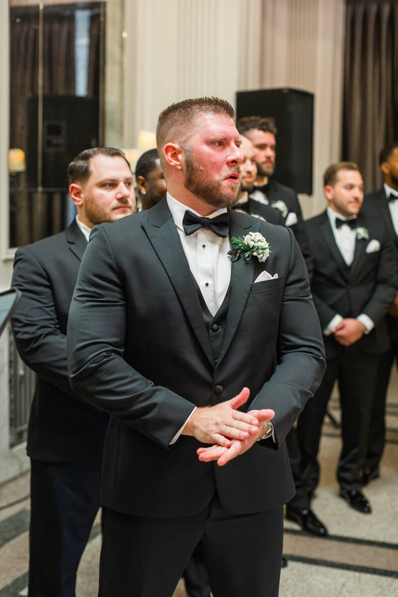 groom crying at bride walking down the aisle