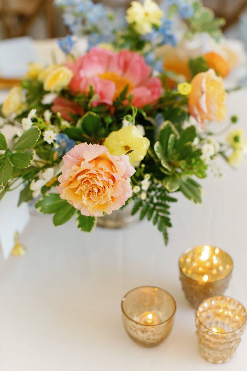 floral arrangement in shades pinks and salmon and candlelight