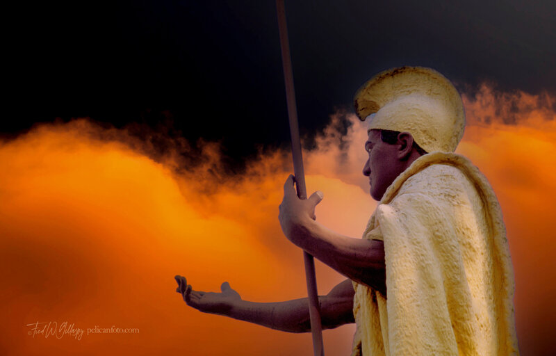Statue of Hawaiian King Kamehameha against a vibrant evening sky in the background.