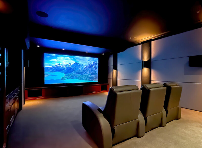 Home theater with projection screen and recliner seating at the CAV showroom in Bluffton