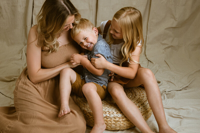 mother tickling son and daughter