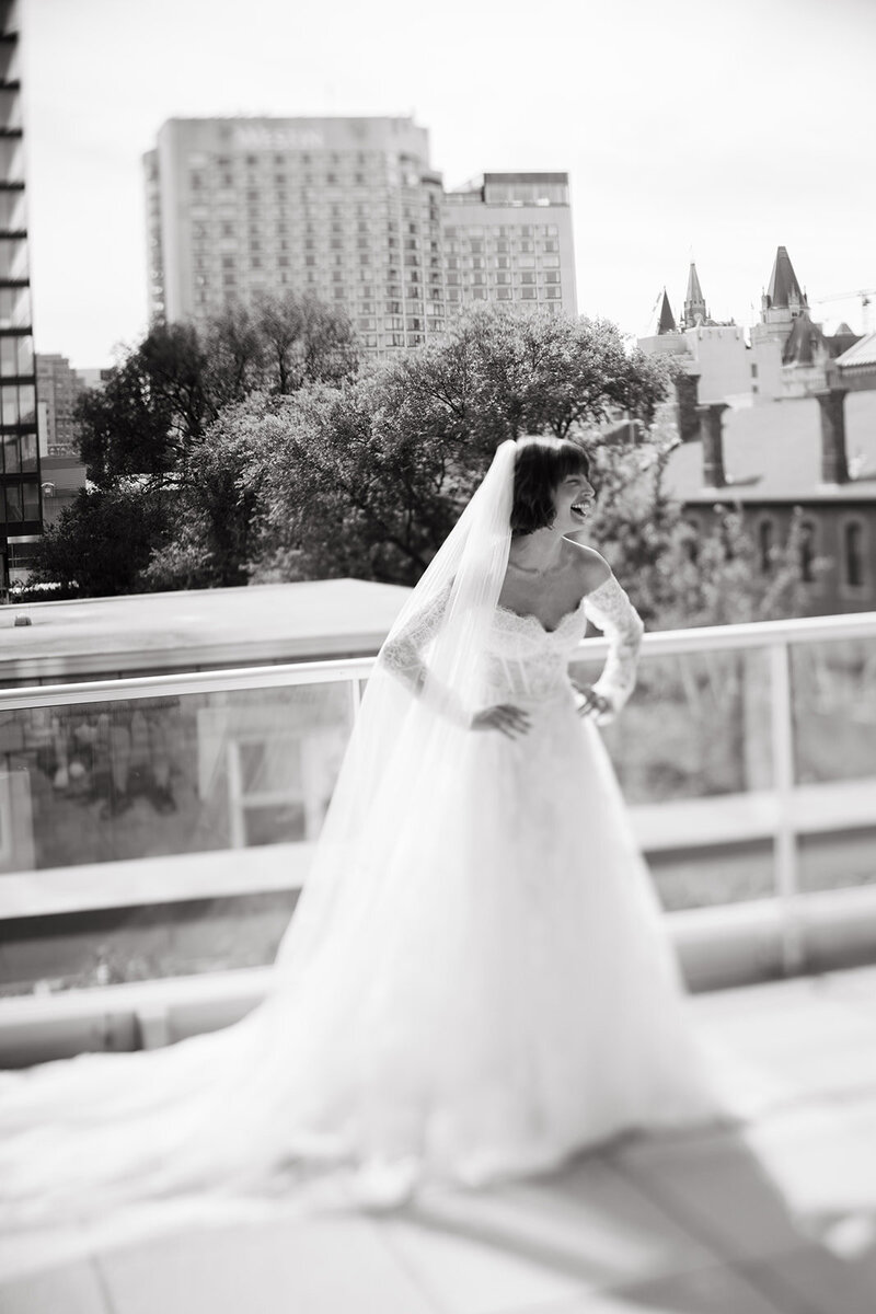 Close-up of couple clinking champagne glasses in black and white — cinematic wedding detail highlighting intimacy and celebration.
