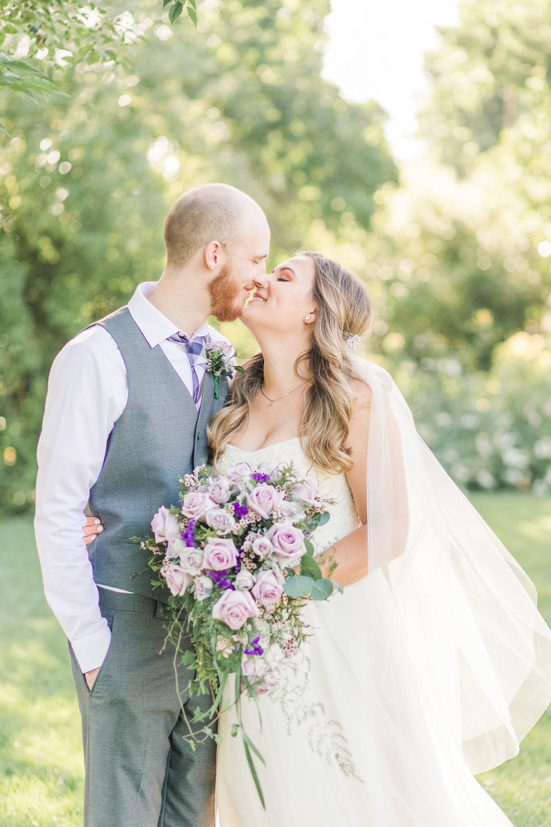 A bride and groom share a kiss at their backyard private estate micro wedding.