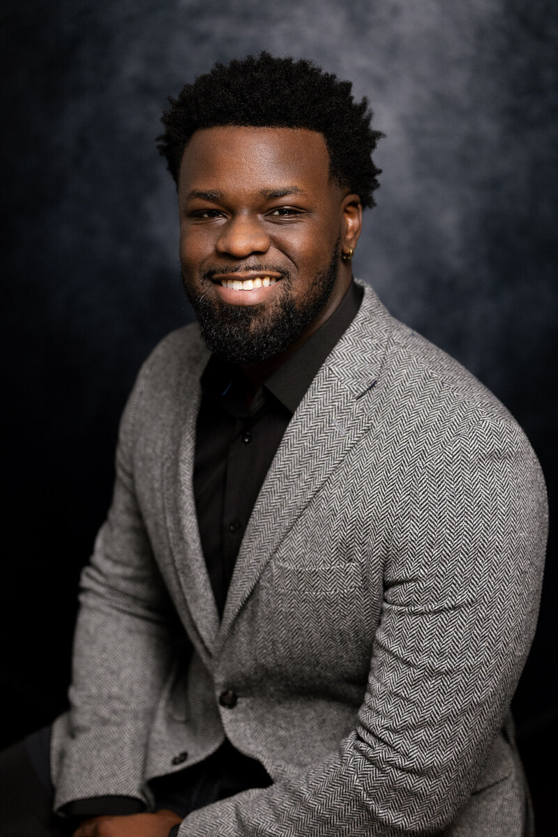 Bryan Smith, owner of B. Smitty Photos, smiling  — editorial wedding and portrait photographer based in Atlanta and Miami.