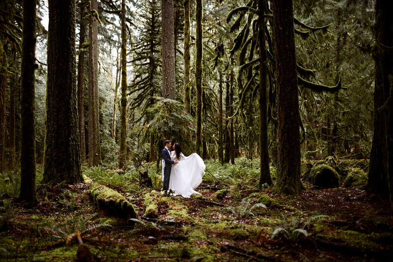 couple in a deep forrest taking wedding photos Oregon Coast Elopement and Wedding Photographer