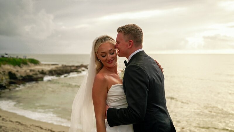 san diego wedding video still groom embracing bride on beach