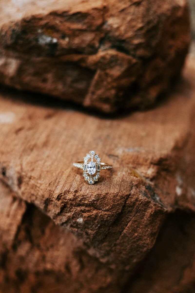 Wedding ring sitting on a rock 