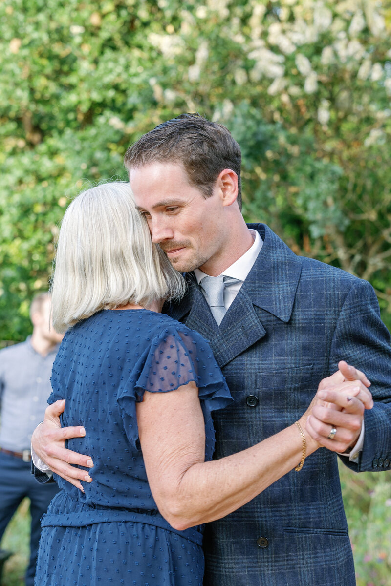 bay area photographers documents mother son dance for a backyard wedding reception with groom and his mother dancing together