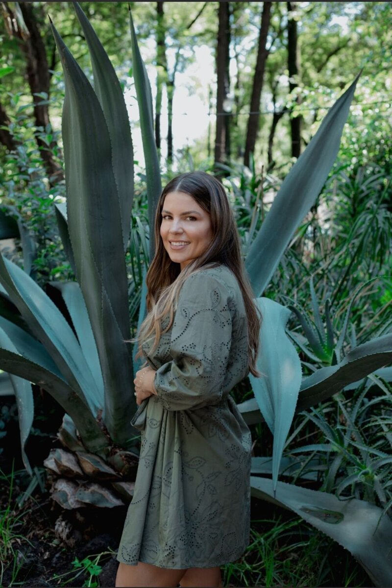 Woman with blonde hair and green plants
