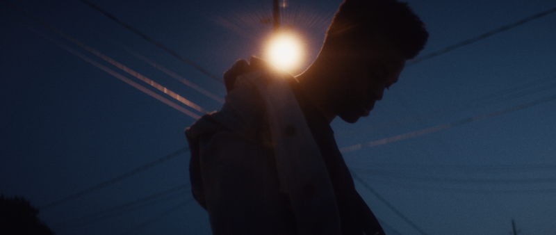 Silhouette of young man with light behind him-FillmCo