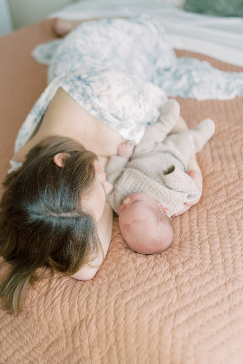 Mom laying on bed with baby by Wichita Falls Photographer