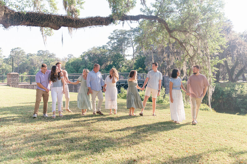Extended family walking under oak trees with Palmetto Bluff Photographer Lamp and Light Photography.