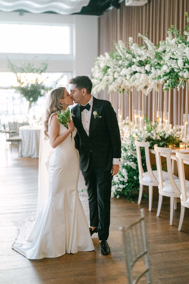 Couple walking through their reception hall at Current Pier 59 in NYC, with planning by Julian Leaver Events