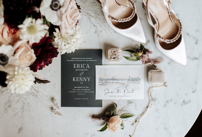 Elegant wedding flatlay featuring invitation suite, bridal shoes, floral details, and jewelry, created by Seattle wedding planner in Tacoma, Wander Event Co