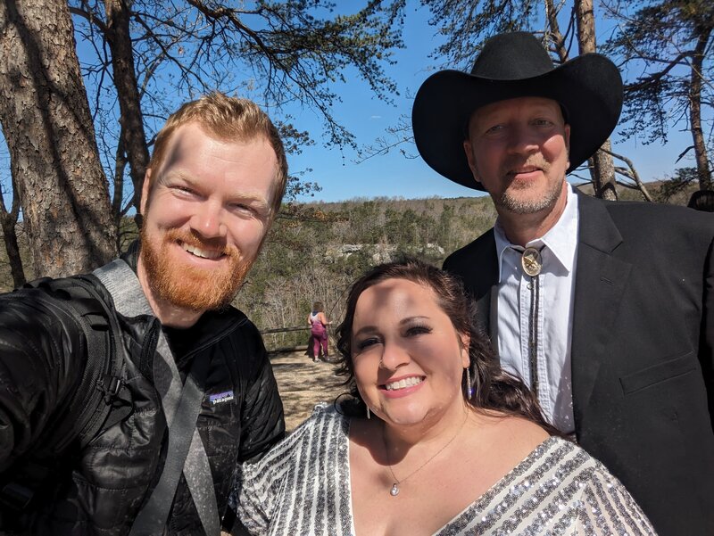 Elopement Photographer smiling for a selfie with wedding couple