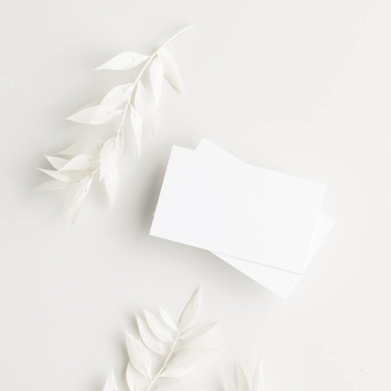 White stacked paper with white flowers - Brenda Chadambura
