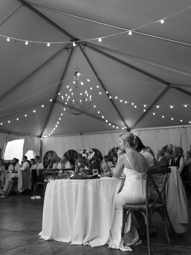 Bride and groom sitting at table taken by wedding photographer in Frederick MD