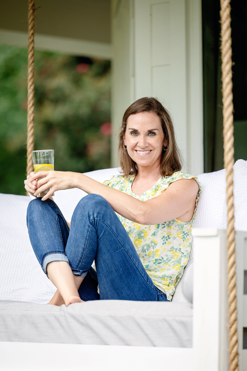 a woman sitting on a porch swing