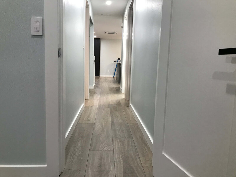 Wood-look vinyl plank flooring installed in a bright, modern hallway