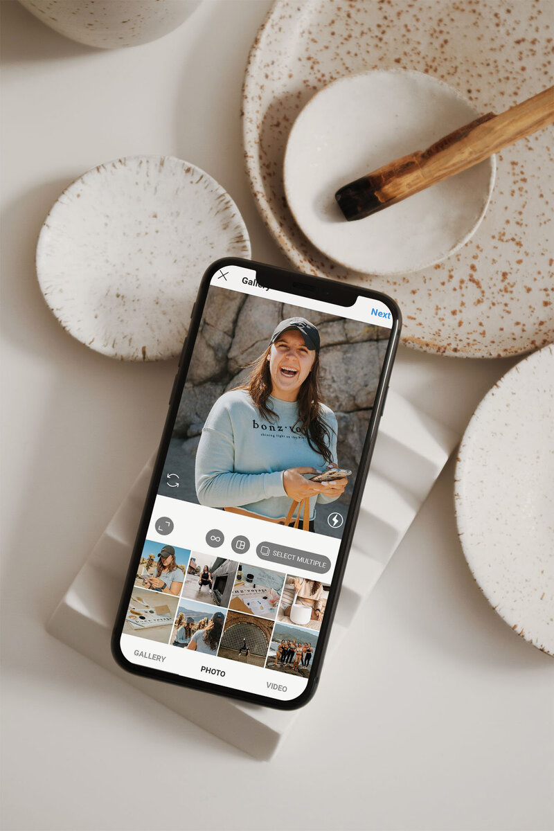 Mock-up of Instagram posting on iPhone showing brand photography by Emma Leigh Studios.