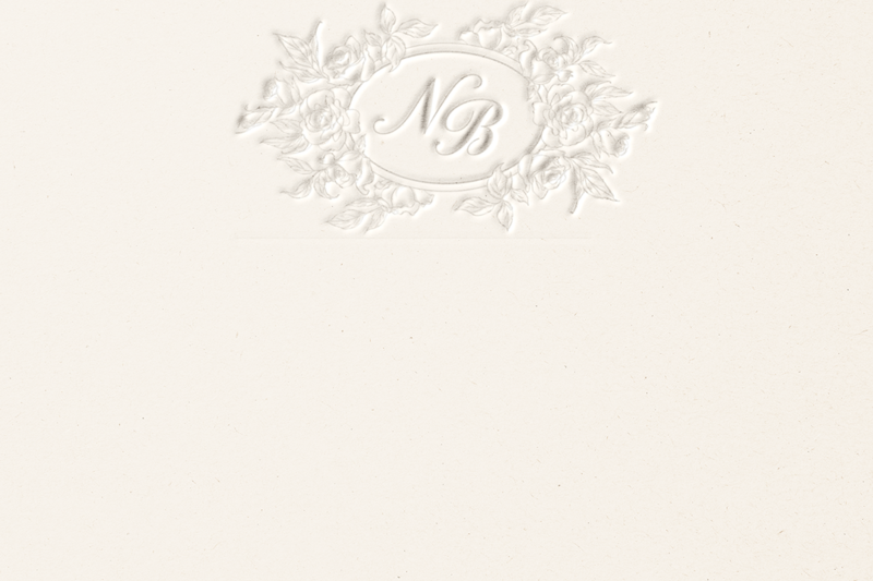 A beige notecard with a floral embossed logo of N B.