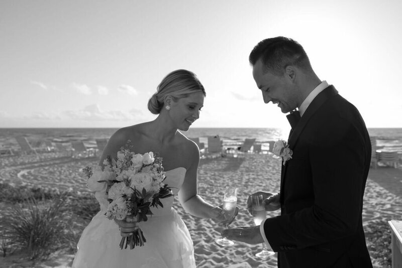 bride and groom on beach with champagne taken by fort myers wedding photographer