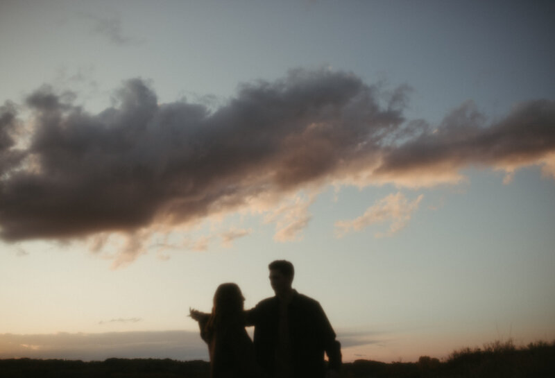Silhouette of Darian and Kelsea during a romantic sunset couples session at Pike Lake, Saskatchewan, photographed by Kayla Cassidy Photography.
