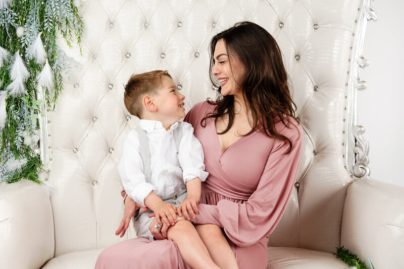 st-louis-mother's-day-mini-sessions-mom-looking-at-son-sitting-on-her-lap