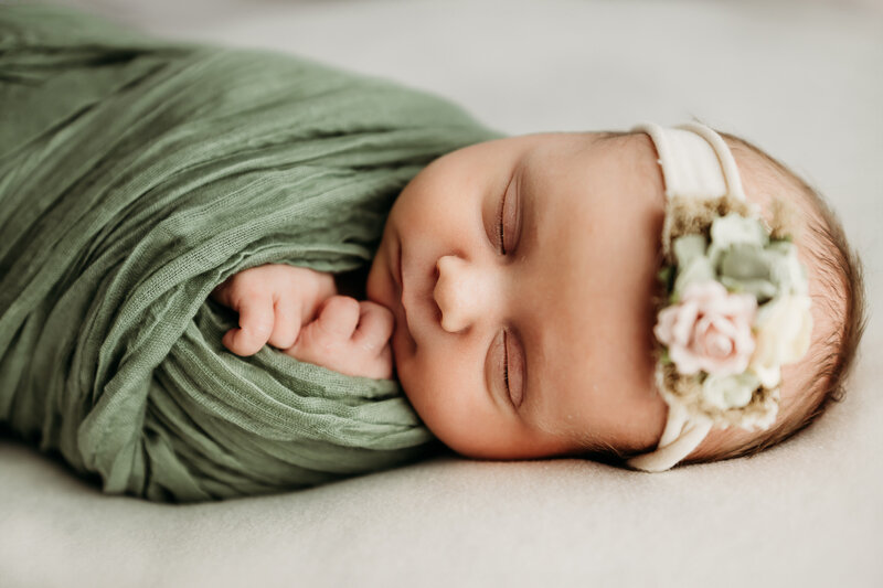 a sweetly sleeping newborn girl at her photography session