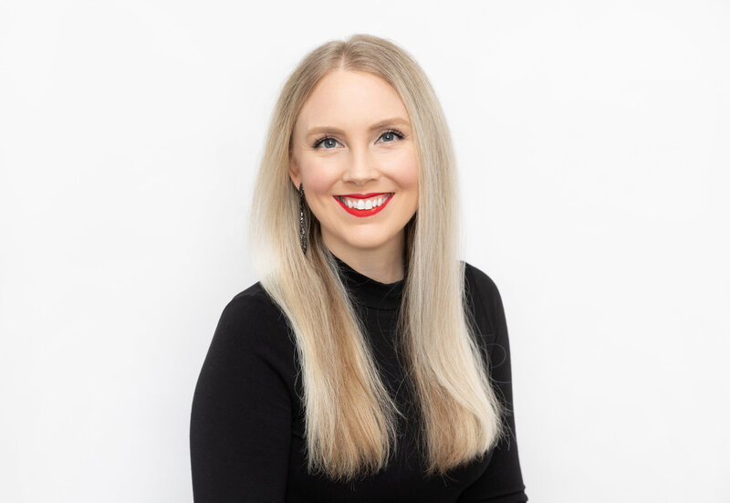 Kristyn in a black turtleneck smiling