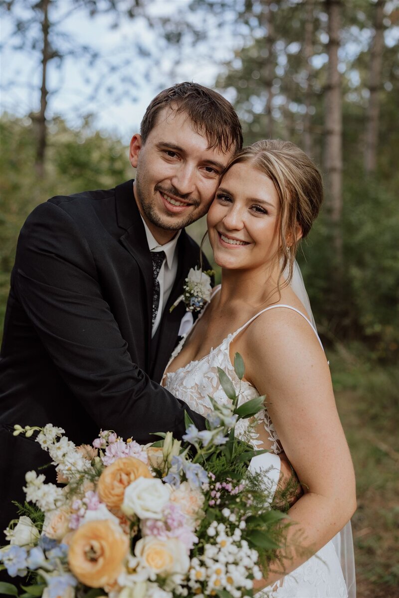 bride and groom smiling at camera