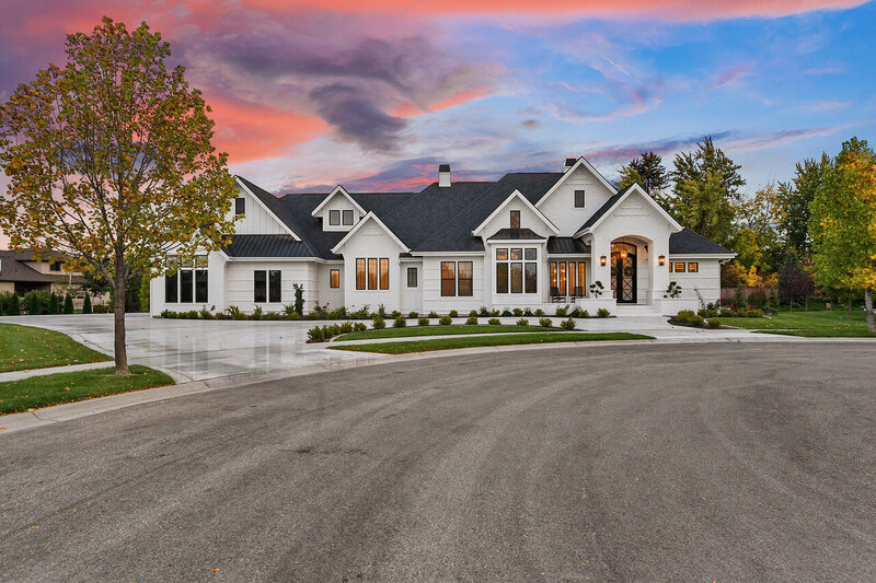 Sunset exterior shot of The Alabaster Estate project by Eagle Idaho luxury custom home builder and architect Thompson Homes